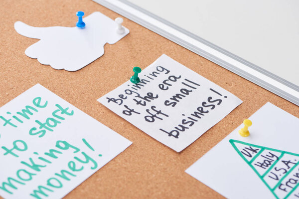 cards with work notes and like sign pinned on cork office board