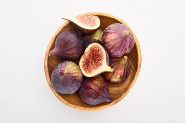 top view of ripe delicious figs in wooden bowl on white background clipart