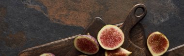 top view of tasty figs and wooden cutting boards on stone background, panoramic shot clipart