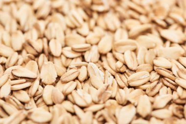 close up view of uncooked pressed organic oats clipart