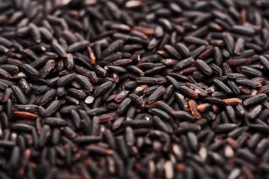close up view of uncooked organic black rice clipart