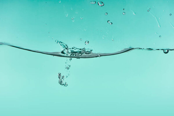wavy transparent water on turquoise background with splash and bubbles