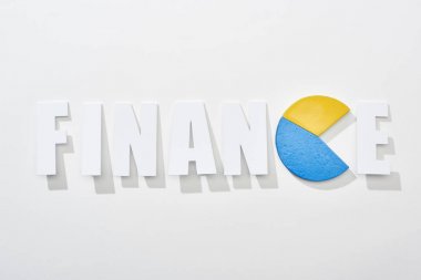 top view of finance inscription with yellow and blue pie diagram instead e letter on white background clipart