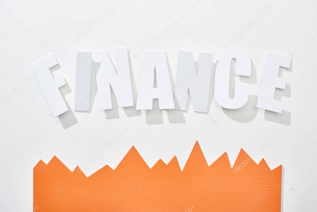 top view of finance inscription with orange statistic graph on white background