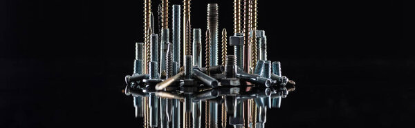 panoramic shot of various shiny metallic screws isolated on black with copy space