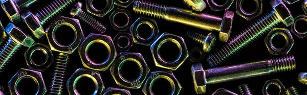 panoramic shot of scattered metallic bolts and nuts isolated on black