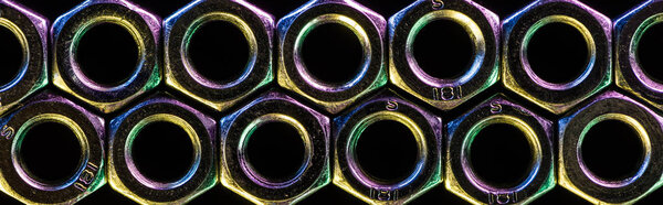 panoramic shot of seamless pattern of metal nuts isolated on black