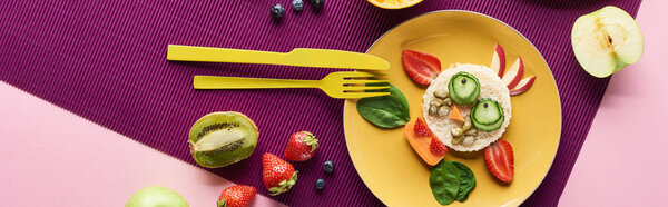 top view of plate with fancy cow made of food near fruits on purple background, panoramic shot