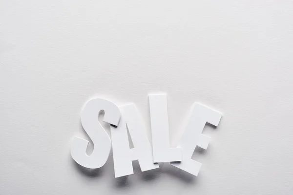 top view of white sale lettering on white background