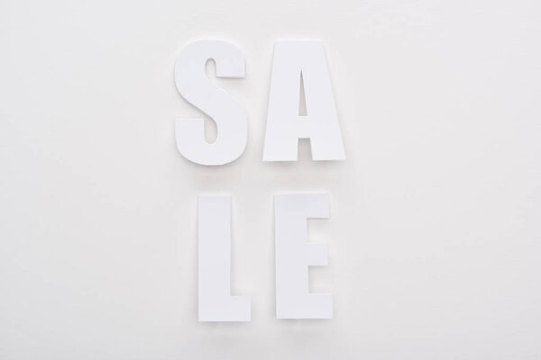 top view of white sale lettering on white background