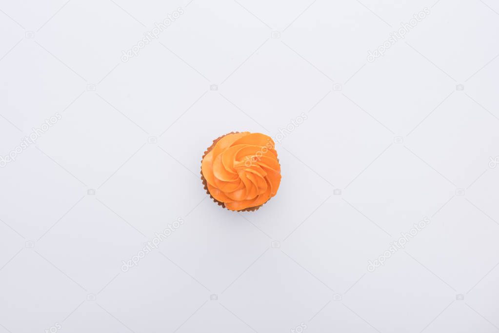 top view of orange delicious Halloween cupcake isolated on white