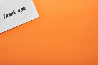 top view of thank you card on orange background clipart