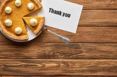 top view of tasty pumpkin pie and thank you card on wooden rustic table clipart