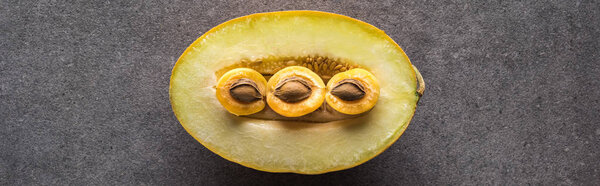 top view of melon and apricots on grey background with copy space, panoramic shot