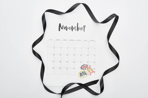 верхний вид календаря с 29 ноября отмечена дата на белом фоне с черной лентой
