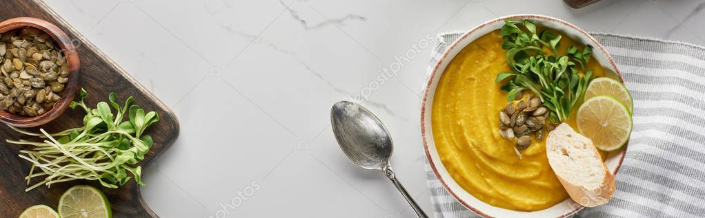 Panoramic shot of tasty mashed pumpkin soup on wooden cutting board with ingredients on marble surface — Stock Image Panoramic Shot Tasty Mashed Pumpkin Soup Wooden Cutting Board Ingredients Royalty Free Stock Photos