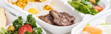 Beyaz arka planda mısır, et, sahanda yumurta ve salata ile ekolojik çekim 