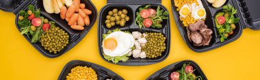 panoramic shot of eco packages with vegetables, apples, meat, fried eggs and salads isolated on yellow     clipart
