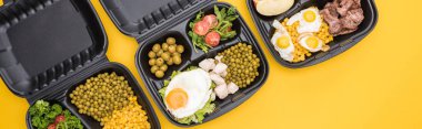 panoramic shot of eco packages with vegetables, meat, fried eggs and salads isolated on yellow     clipart