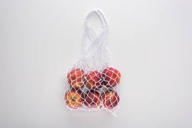 top view of apples in eco friendly string bag isolated on white clipart
