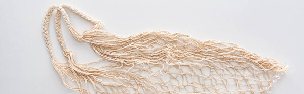 top view of empty beige eco friendly string bag isolated on white, panoramic shot