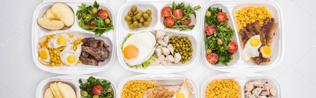 panoramic shot of eco packages with apples, vegetables, meat, fried eggs and salads on white background 