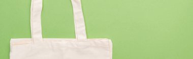top view of empty cotton eco bag isolated on green, panoramic shot clipart