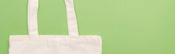 top view of empty cotton eco bag isolated on green, panoramic shot
