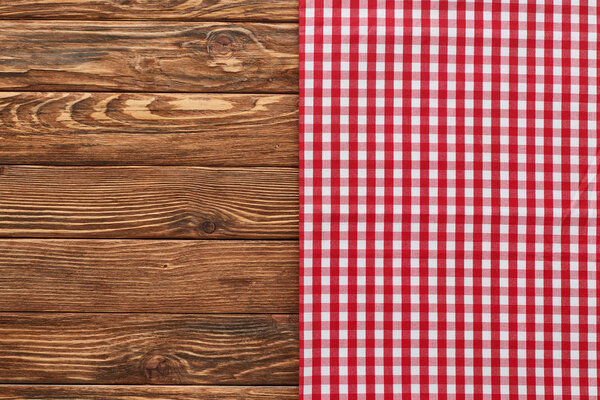 top view of red plaid napkin on wooden table