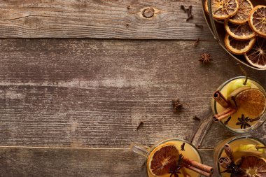 top view of traditional pear mulled wine with spices on wooden rustic table with copy space clipart