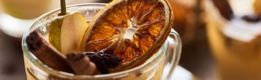 close up view of delicious pear mulled wine with spices and dried citrus, panoramic shot clipart