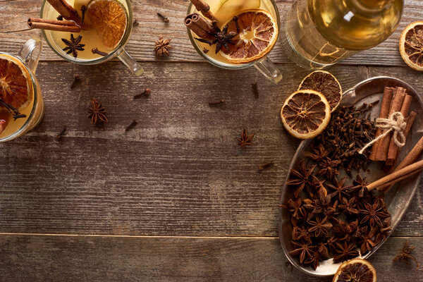 top view of traditional pear mulled wine with spices on wooden rustic table