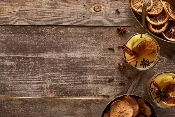 top view of traditional pear mulled wine with spices on wooden rustic table with copy space