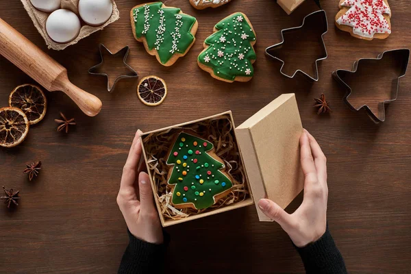 Cropped View Woman Closing Gift Box Christmas Tree Cookie Wooden — Stock Photo, Image
