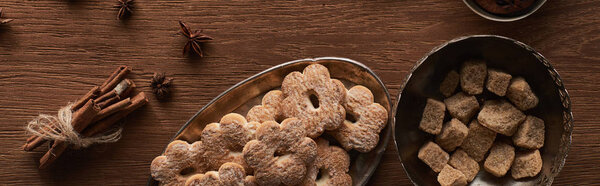 top view of Christmas cookies on wooden table with anise and cinnamon, panoramic shot