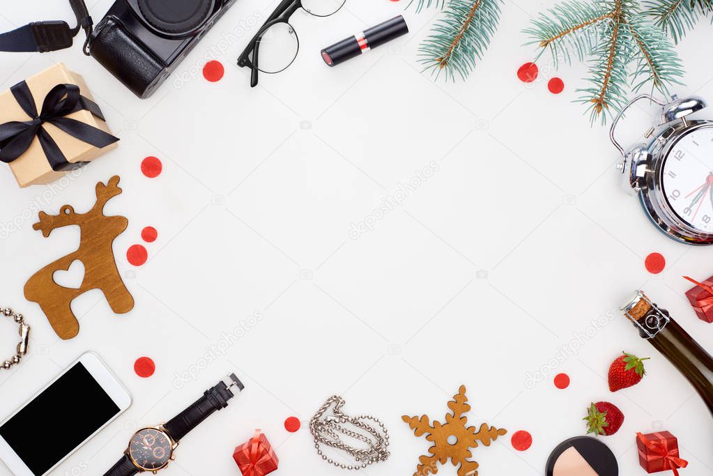 digital camera, smartphone, glasses, christmas baubles, fir branch, wristwatch, champagne bottle, cosmetics, fresh strawberry, alarm clock isolated on white