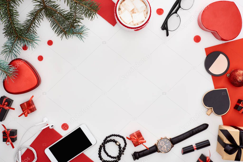 gift boxes, coffee with marshmallow, smartphone, fir branch, wristwatch, cosmetics, christmas baubles, glasses, wristwatch isolated on white
