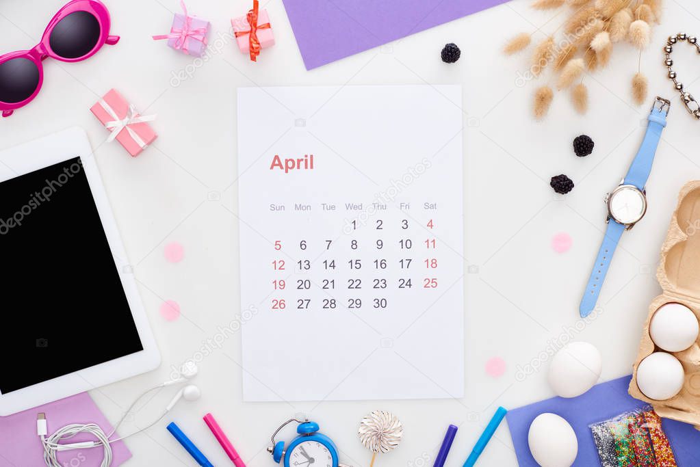 april calendar page, digital tablet, sunglasses, pastry sprinkles, chicken eggs, blackberry, spikelets, wristwatch, toy alarm clock, earphones isolated on white