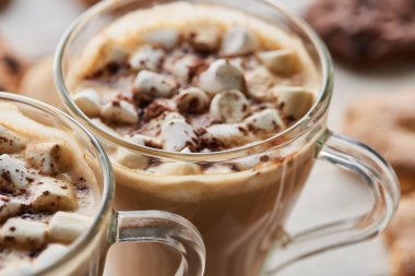 close up view of cacao with marshmallow in mugs clipart