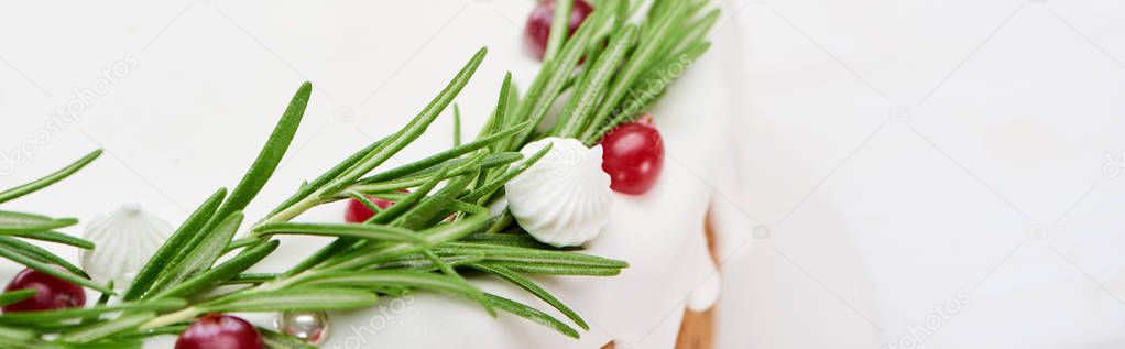 close up of christmas pie with icing, rosemary and cranberries  