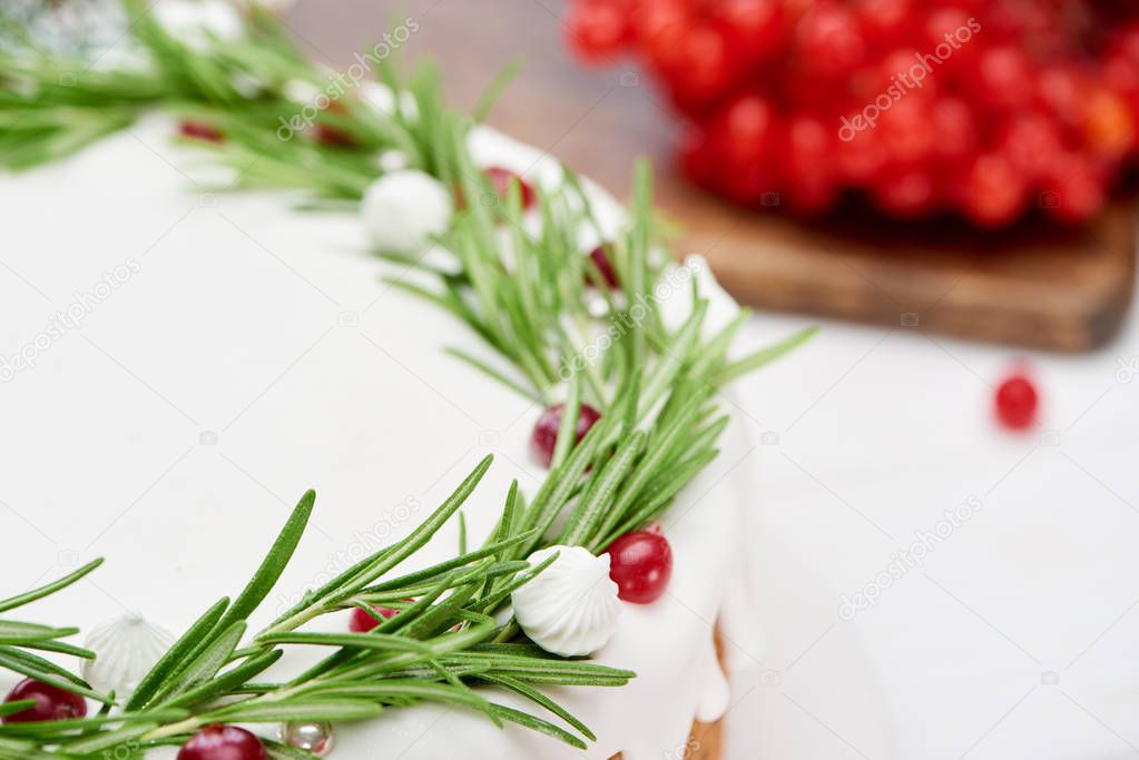 close up of christmas pie and viburnum berries on white wooden table 