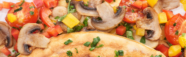 close up of homemade wrapped omelet with mushrooms and peppers