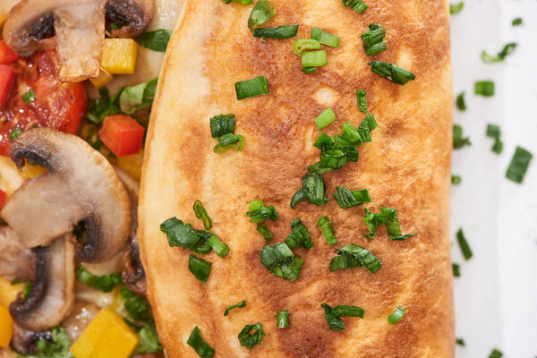 close up of homemade wrapped omelet with vegetables