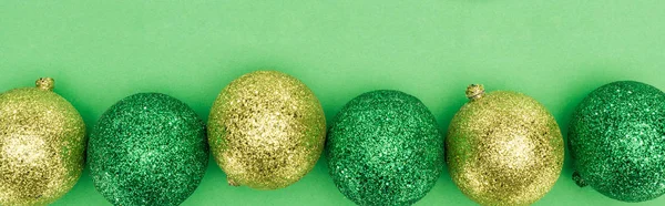 Top View Golden Green Christmas Baubles Green Background Panoramic Shot — Stok Foto