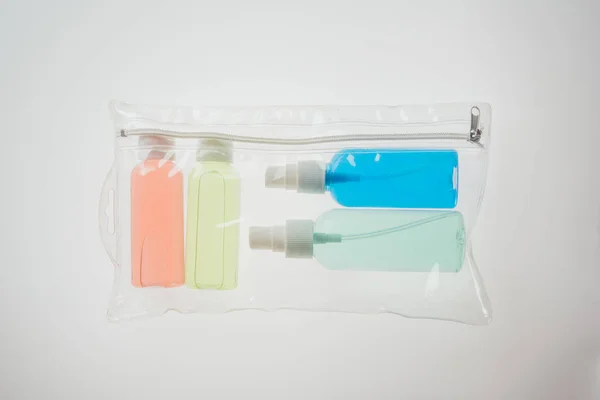 Draufsicht Auf Bunte Flaschen Mit Flüssigkeiten Kosmetikbeutel Auf Weißem Hintergrund — Stockfoto