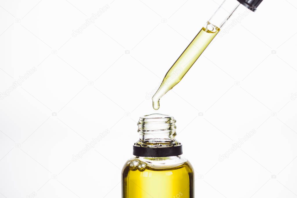 bottle and dropper with natural serum isolated on white