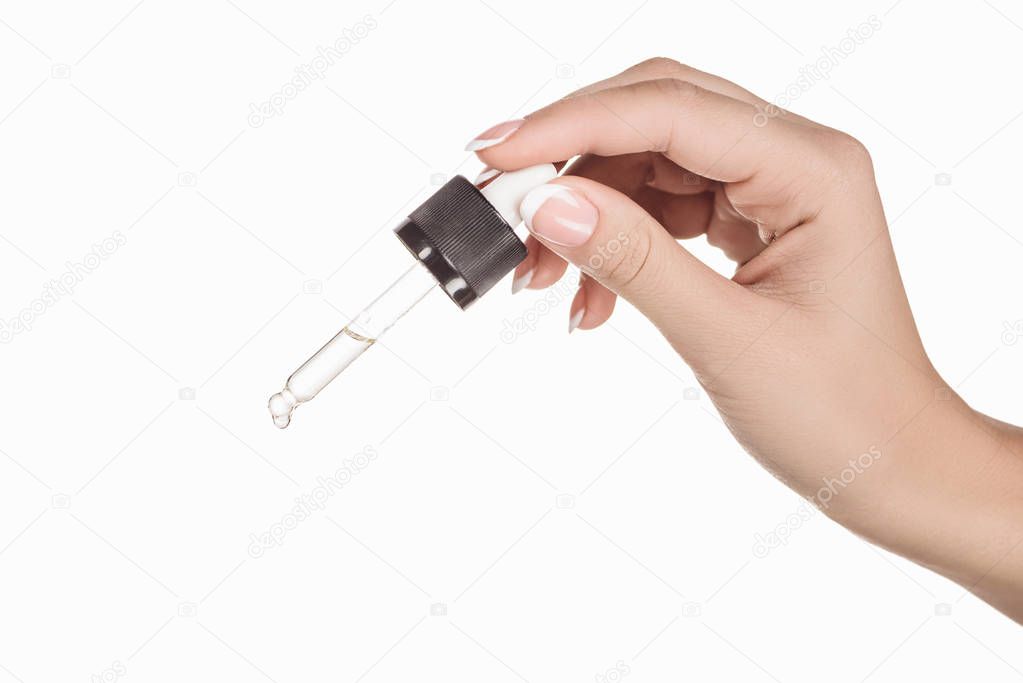 cropped view of woman holding dropper with natural serum isolated on white