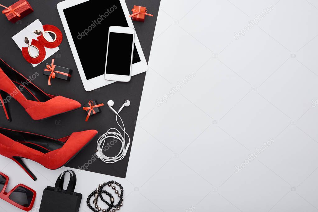 top view of heels, gadgets, gift boxes, sunglasses, earrings, earphones, bracelets, bag 