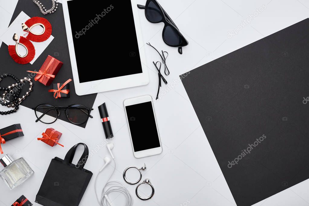 top view of gadgets, gift boxes, sunglasses, perfume, glasses, earrings, earphones, bracelets, bag