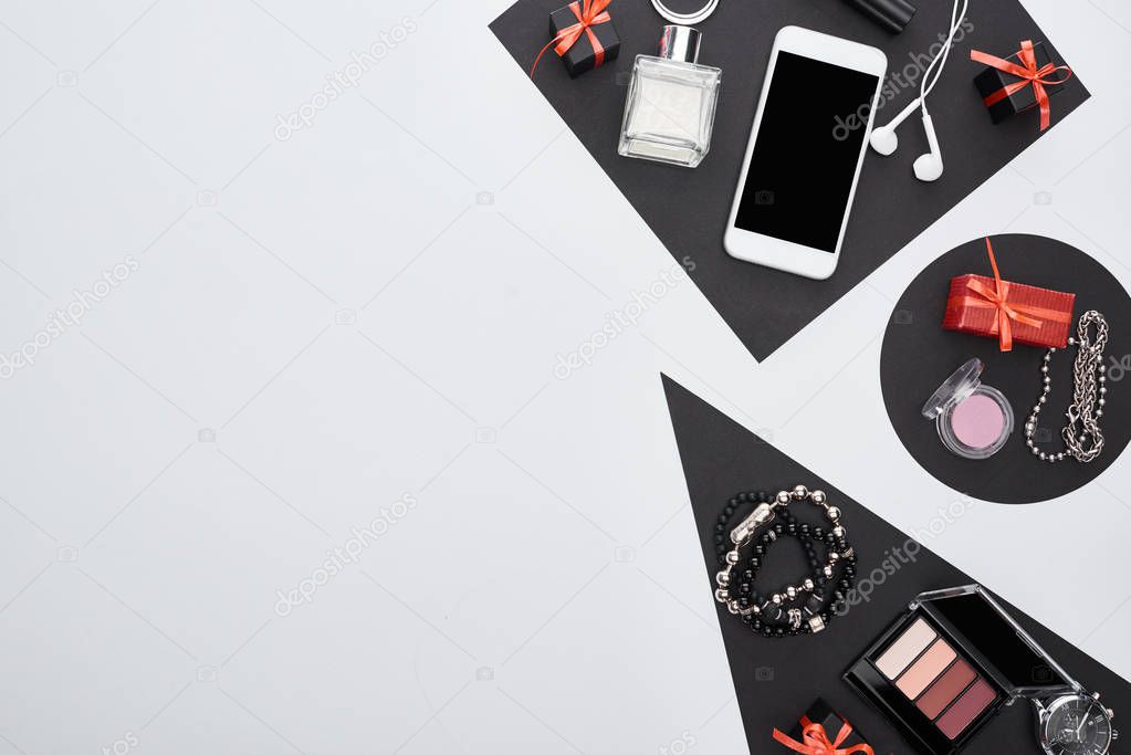 top view of gadget, gift boxes, perfume, bracelets, decorative cosmetics, earphones